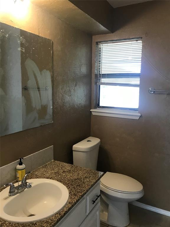 bathroom featuring vanity and toilet