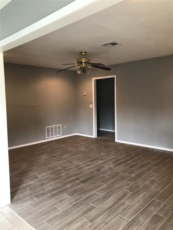 empty room with ceiling fan and wood-type flooring