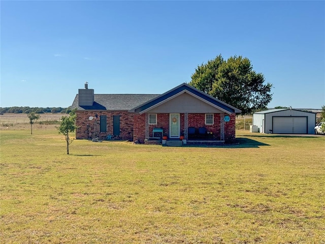 ranch-style house with an outdoor structure, a front yard, and a garage