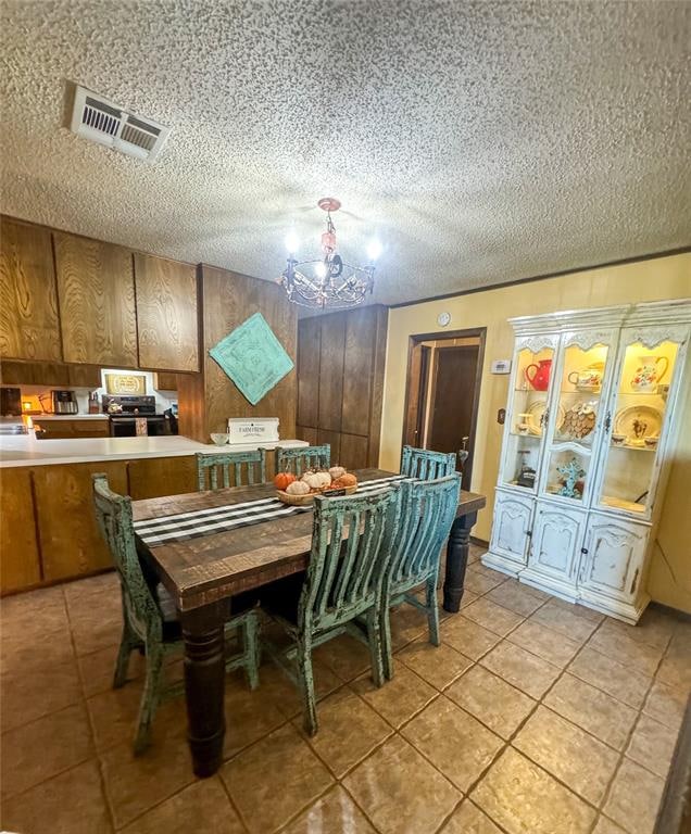 dining space featuring light tile patterned floors and a textured ceiling