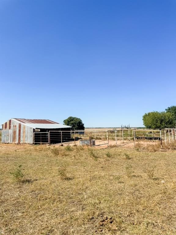 view of yard featuring an outbuilding and a rural view