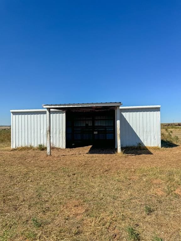 view of outbuilding featuring a lawn