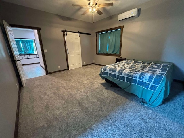 carpeted bedroom featuring a wall unit AC, a barn door, and ceiling fan