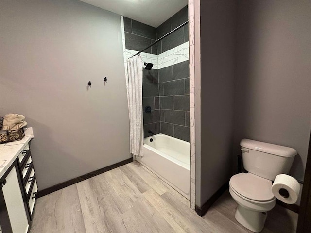 bathroom featuring wood-type flooring, shower / bath combo, and toilet