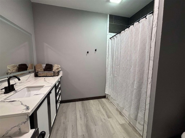 bathroom featuring hardwood / wood-style flooring, vanity, and a shower with shower curtain