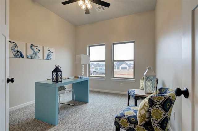 office space featuring light carpet, baseboards, visible vents, and ceiling fan