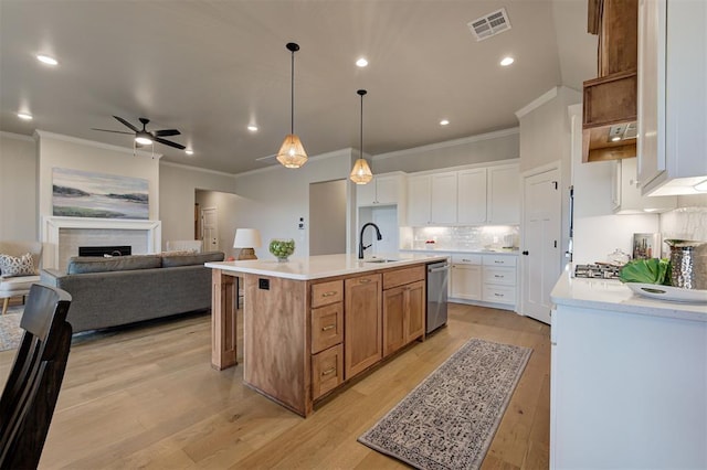 kitchen with visible vents, decorative backsplash, open floor plan, stainless steel appliances, and a sink