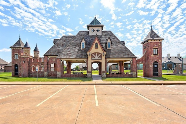 view of building exterior with uncovered parking