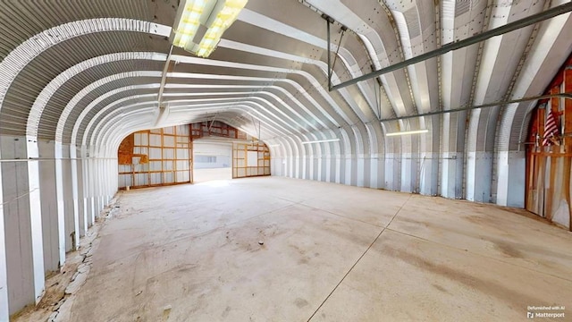 misc room featuring vaulted ceiling and concrete floors