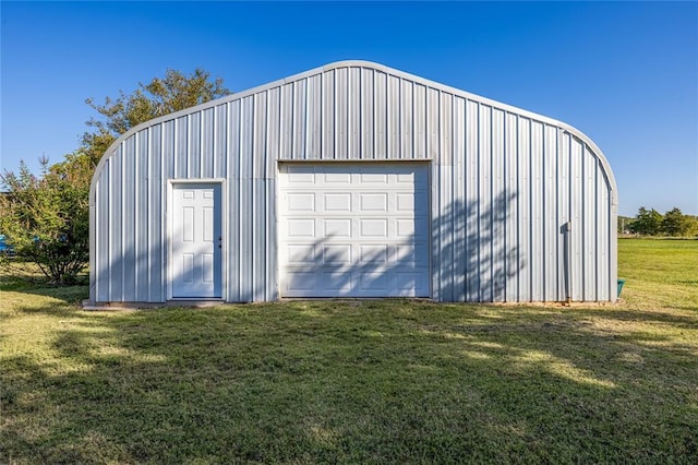 garage featuring a lawn