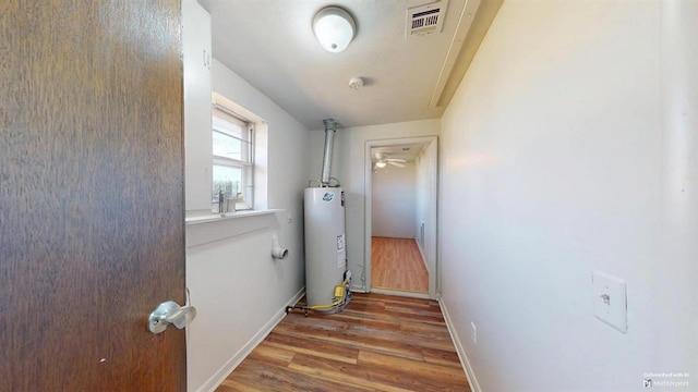 corridor featuring gas water heater and wood-type flooring