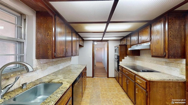 kitchen featuring sink, black appliances, light stone counters, and tasteful backsplash