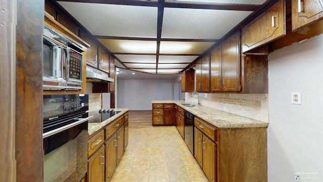 kitchen with sink, tasteful backsplash, black appliances, and light stone counters