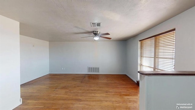 spare room with light wood-type flooring and ceiling fan