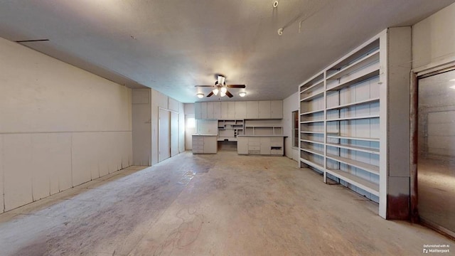 unfurnished living room featuring ceiling fan