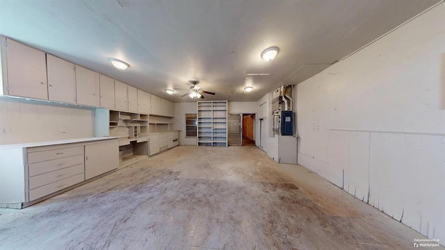 garage with electric panel and ceiling fan