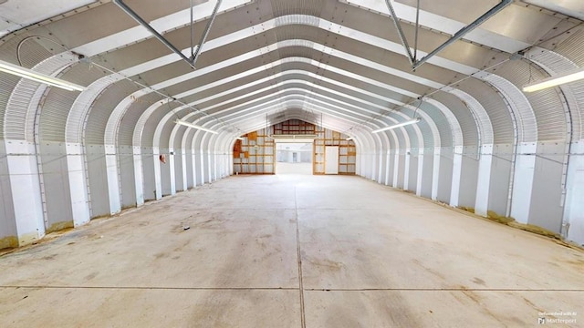 miscellaneous room featuring vaulted ceiling and concrete flooring