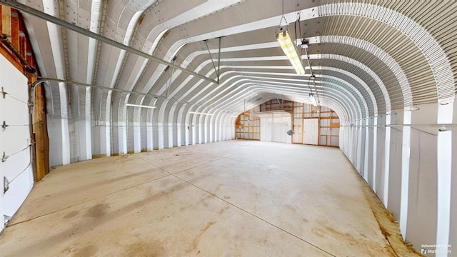 misc room featuring vaulted ceiling and concrete flooring