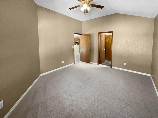 carpeted empty room featuring ceiling fan and lofted ceiling