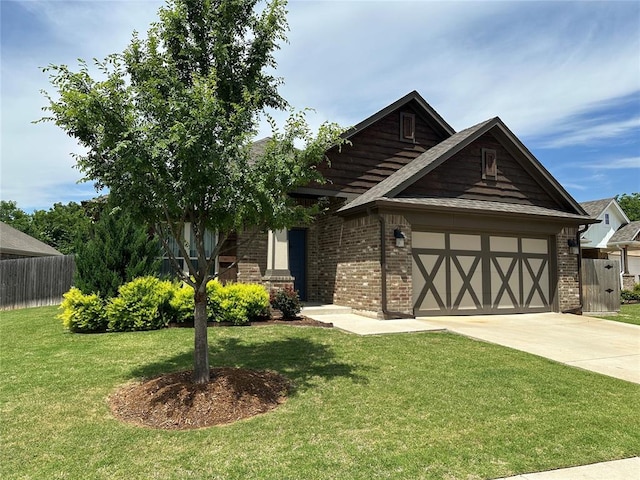 view of front of property featuring a front yard and a garage