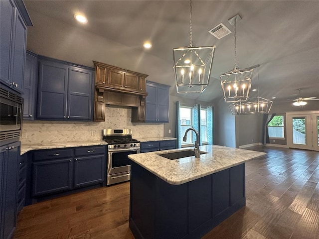 kitchen with dark hardwood / wood-style flooring, stainless steel appliances, ceiling fan, sink, and a center island with sink