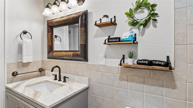 bathroom with vanity and tile walls