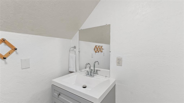 bathroom featuring vanity and vaulted ceiling