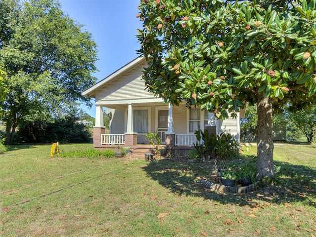 view of front of home with a front lawn and a porch