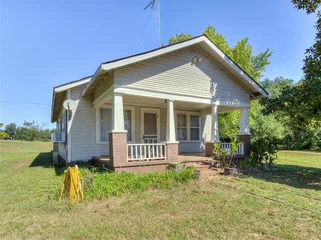 bungalow-style home with a front lawn and covered porch