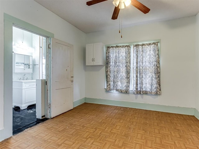 interior space featuring ceiling fan, sink, and light parquet floors