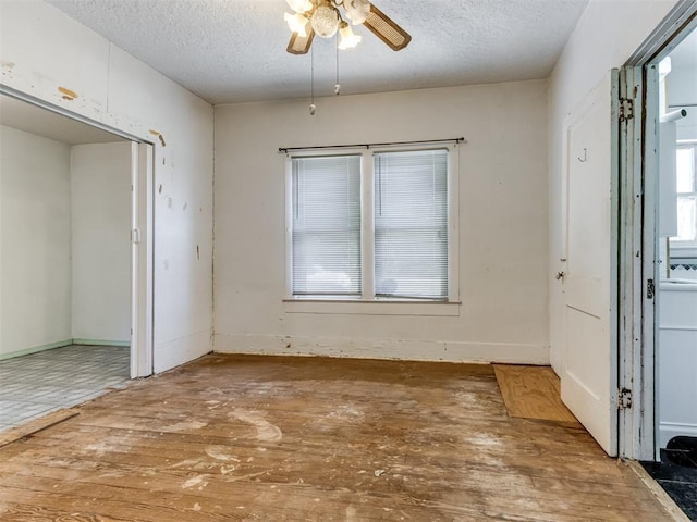 foyer featuring a textured ceiling, hardwood / wood-style flooring, and ceiling fan