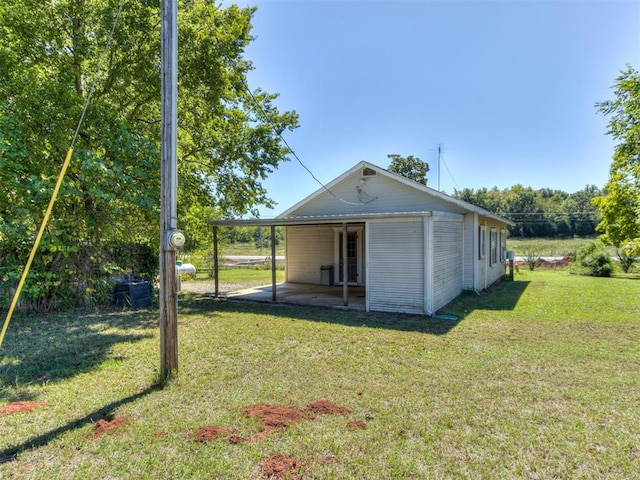 back of property featuring a patio area and a yard