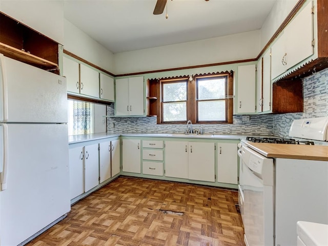 kitchen with white appliances, light parquet floors, sink, ceiling fan, and white cabinetry