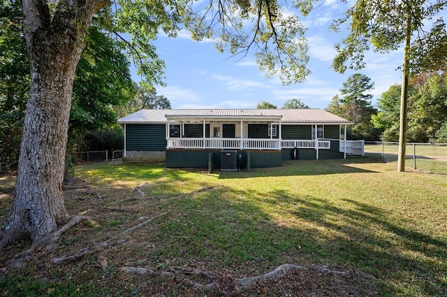 view of front facade with cooling unit and a front yard