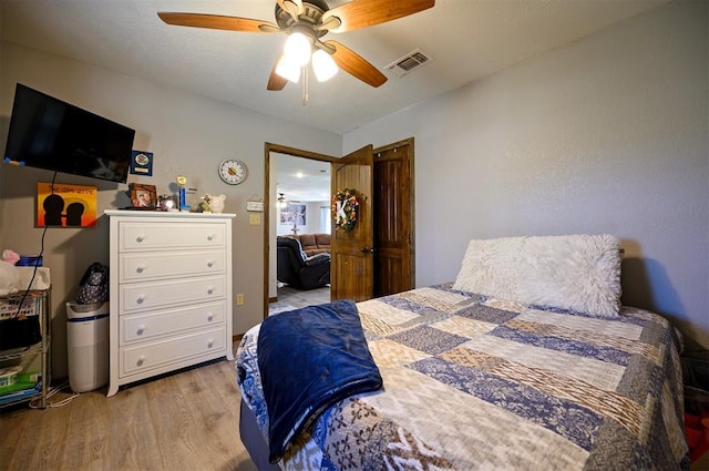 bedroom with ceiling fan and light hardwood / wood-style flooring