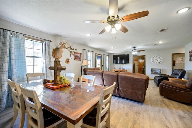 dining space featuring ceiling fan and light hardwood / wood-style floors