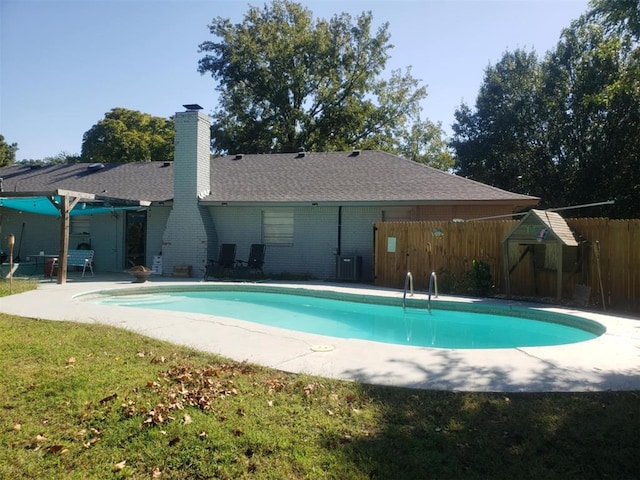 view of swimming pool with central air condition unit and a patio