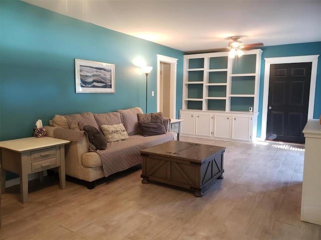 living room featuring light hardwood / wood-style floors and ceiling fan