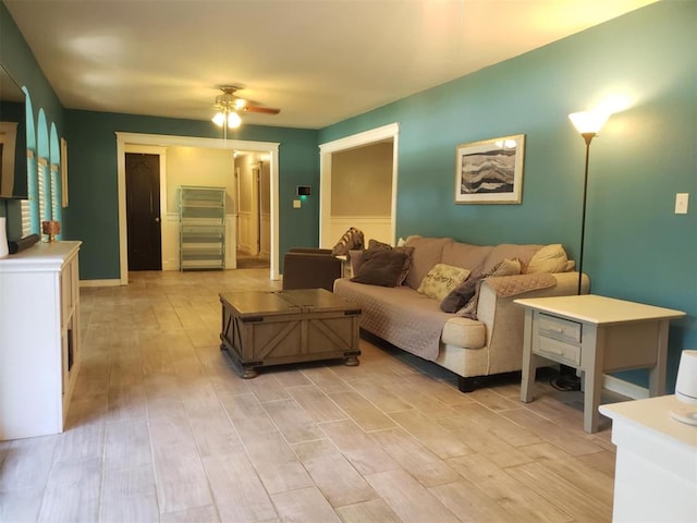 living room with ceiling fan and light hardwood / wood-style floors