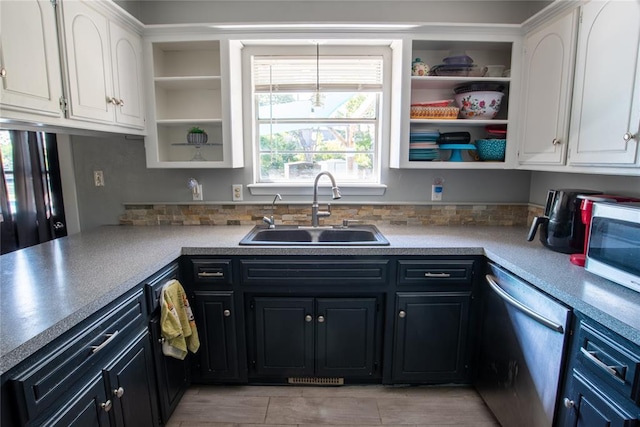 kitchen featuring white cabinetry, stainless steel dishwasher, and sink