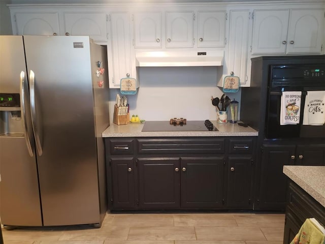 kitchen with black appliances and white cabinetry