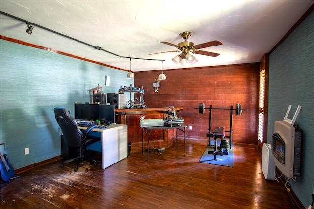 office area with dark hardwood / wood-style flooring, heating unit, ceiling fan, and ornamental molding