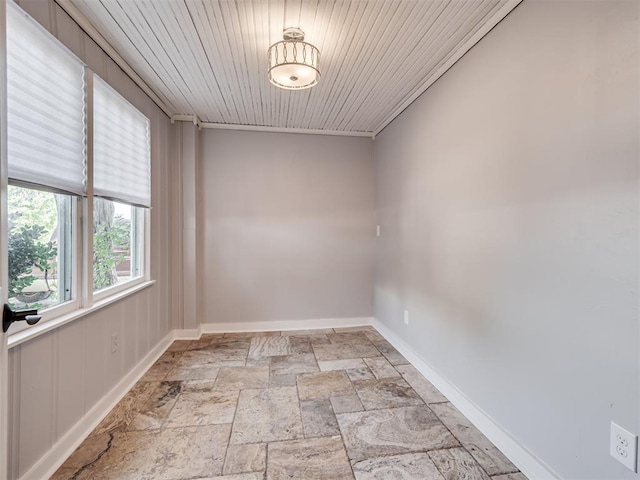 spare room featuring wooden ceiling and crown molding