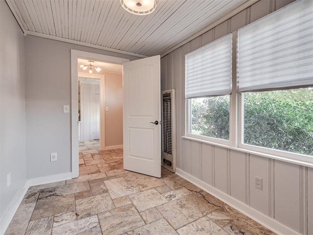 empty room featuring wooden ceiling and a notable chandelier