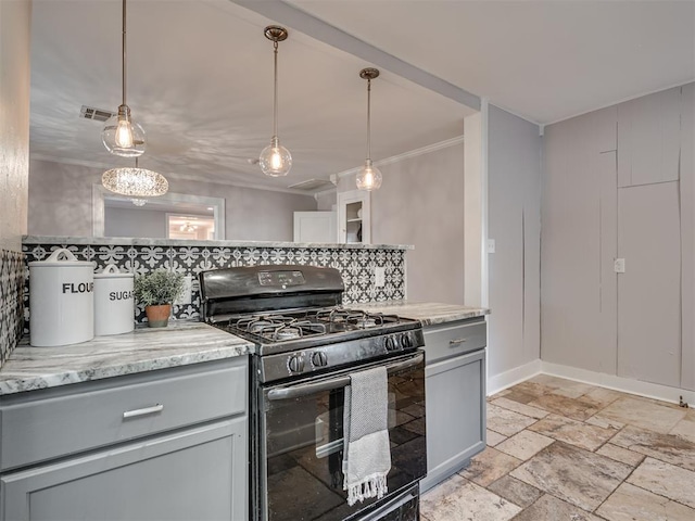 kitchen featuring gas stove, gray cabinetry, light stone counters, and hanging light fixtures