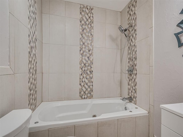 bathroom with tiled shower / bath combo and toilet