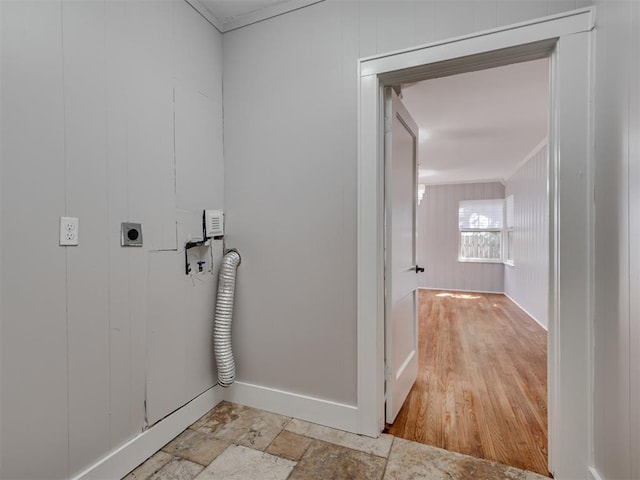 laundry area with light hardwood / wood-style floors, electric dryer hookup, and wood walls