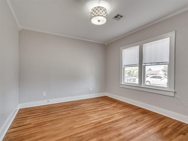 unfurnished room with light hardwood / wood-style floors and crown molding