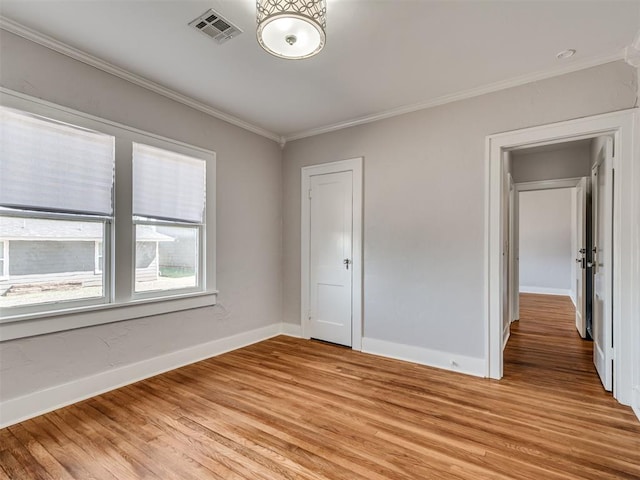 unfurnished bedroom with light hardwood / wood-style floors and ornamental molding