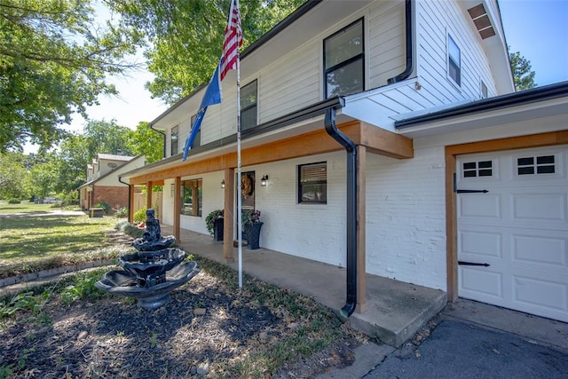 view of home's exterior featuring covered porch and a garage